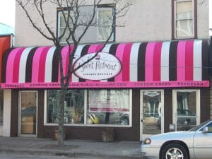 Curved awning with custom graphics and stripes in Twin Cities