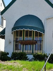 Close up of residential dome awning with scalloped valance