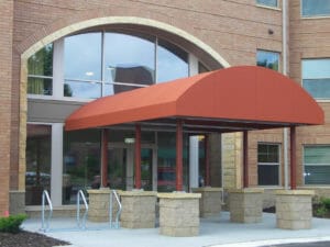 Large half barrel entryway canopy on pillars in Twin Cities