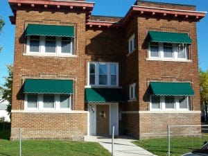 Twin Cities brick 4-plex accented with green window awnings