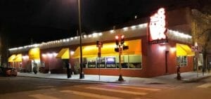 Street view of the full Conga Latin Bistro building at night